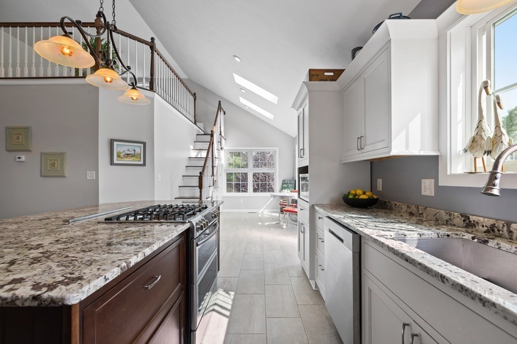 28 Black Point Road Webster, MA 01570 - Photo 11 of 42 a kitchen with a stove a sink and a refrigerator