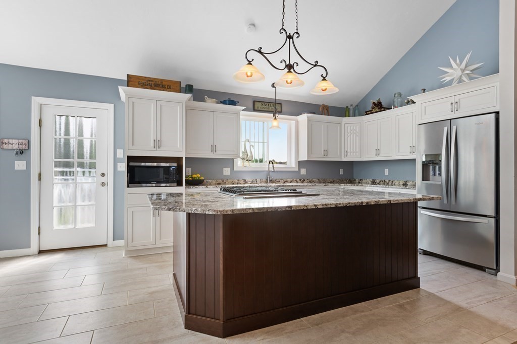 28 Black Point Road Webster, MA 01570 - Photo 12 of 42 a view of a kitchen with stainless steel appliances granite countertop a stove and a refrigerator