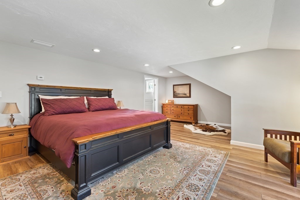 28 Black Point Road Webster, MA 01570 - Photo 25 of 42 a spacious bedroom with a bed and wooden floor
