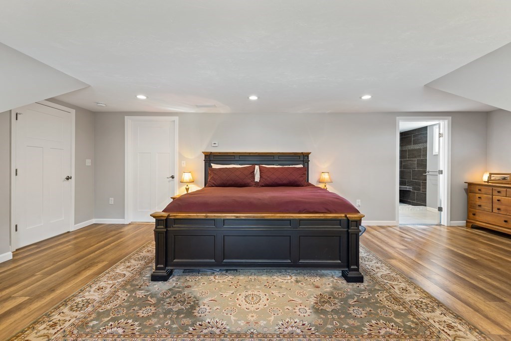 28 Black Point Road Webster, MA 01570 - Photo 27 of 42 a bedroom with a bed and wooden floor
