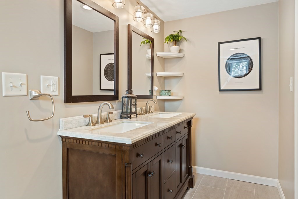 28 Black Point Road Webster, MA 01570 - Photo 29 of 42 a bathroom with a double vanity sink and a mirror