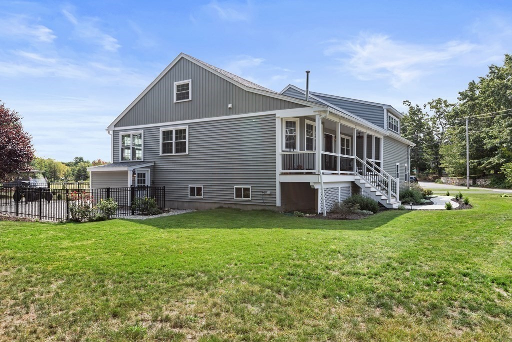 28 Black Point Road Webster, MA 01570 - Photo 3 of 42 a front view of house with yard and trees in the background