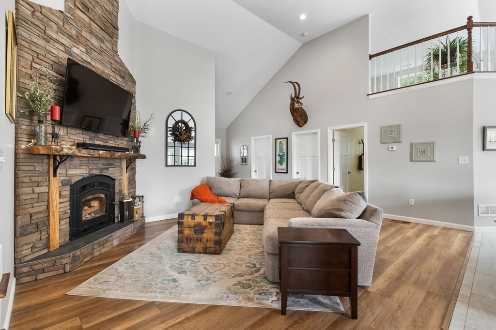 28 Black Point Road Webster, MA 01570 - Photo 5 of 42 a living room with furniture a flat screen tv and a fireplace