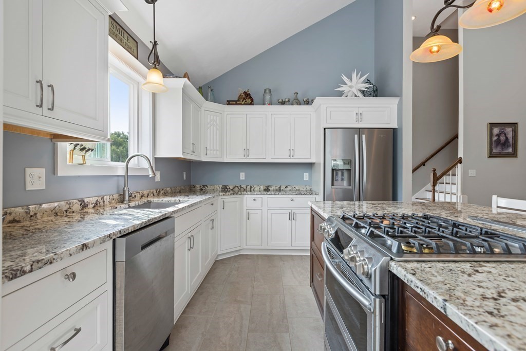 28 Black Point Road Webster, MA 01570 - Photo 9 of 42 a kitchen with a sink stove and cabinets