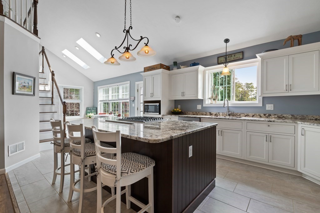 28 Black Point Road Webster, MA 01570 - Photo 10 of 42 a kitchen with granite countertop stainless steel appliances a sink and a refrigerator
