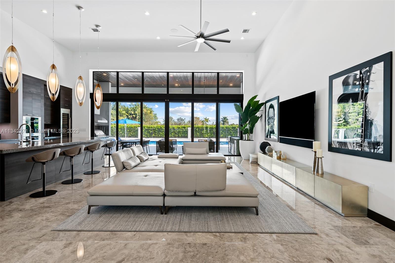 2610 Oak Park Drive Davie, FL 33325 - Photo 12 of 60 a living room with furniture tv and a large window