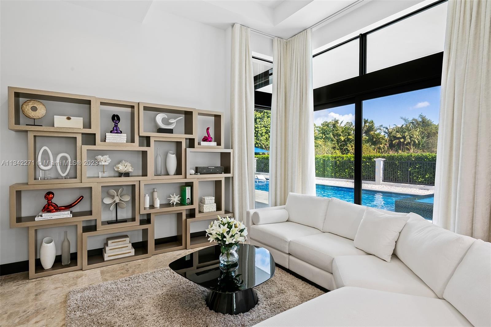 2610 Oak Park Drive Davie, FL 33325 - Photo 22 of 60 a living room with furniture and a floor to ceiling window