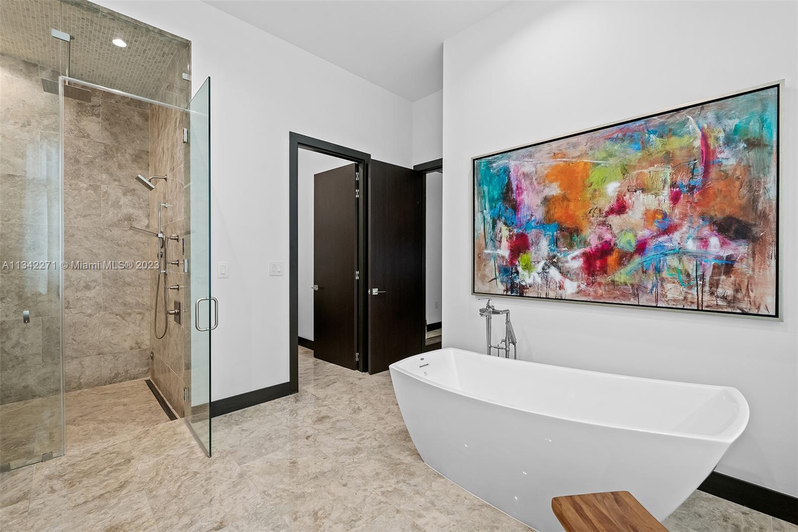 2610 Oak Park Drive Davie, FL 33325 - Photo 24 of 60 a bathroom with a bathtub and a painting on the wall