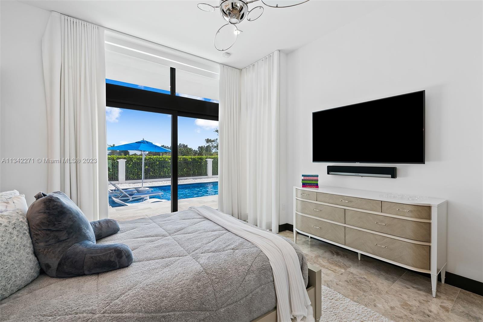 2610 Oak Park Drive Davie, FL 33325 - Photo 27 of 60 a bedroom with a bed and a flat tv screen on dresser