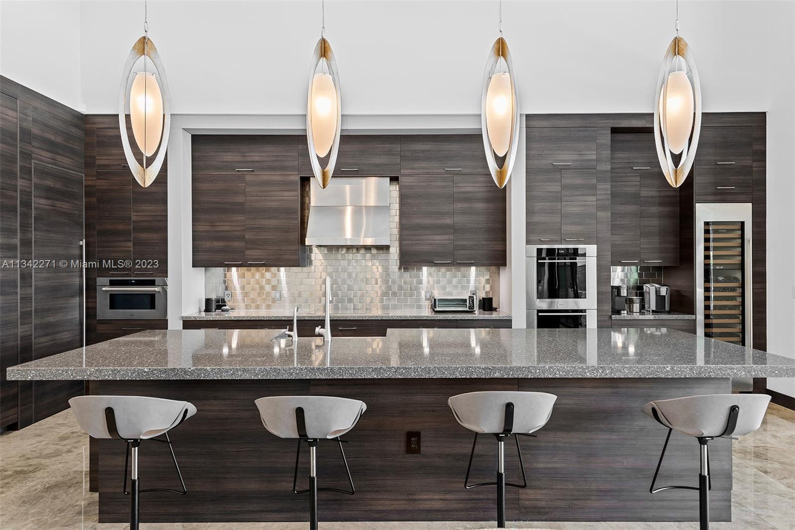 2610 Oak Park Drive Davie, FL 33325 - Photo 3 of 60 a kitchen with stainless steel appliances granite countertop a kitchen island a stove and a wooden cabinets