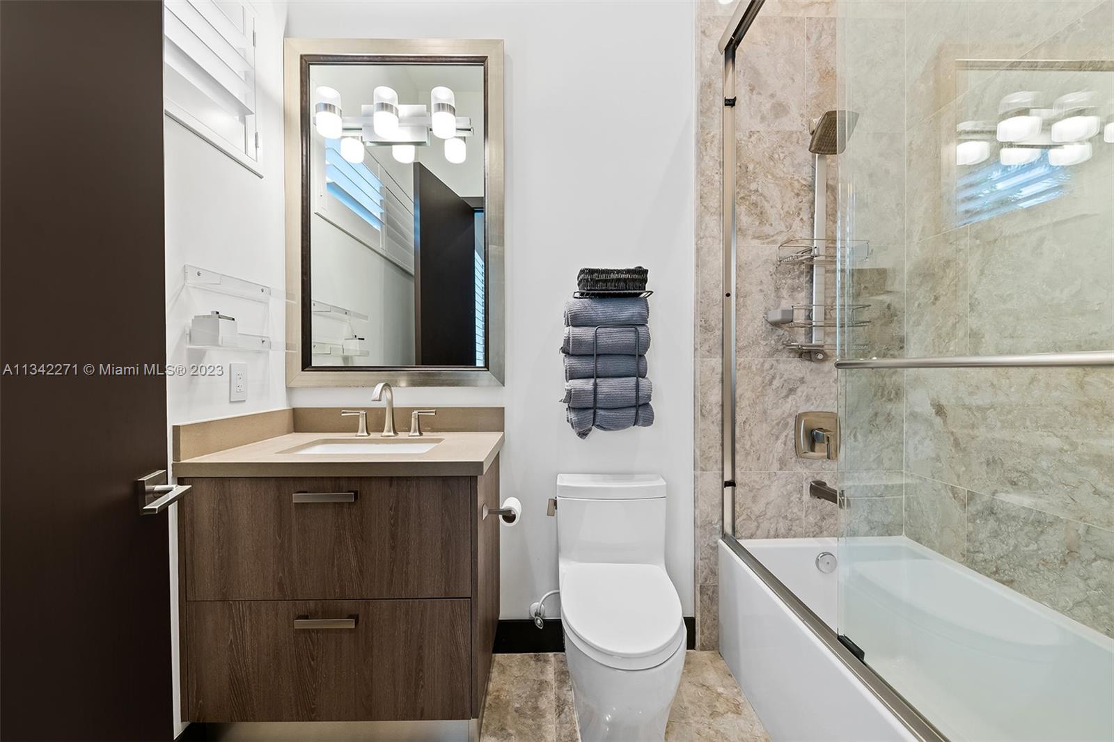 2610 Oak Park Drive Davie, FL 33325 - Photo 32 of 60 a bathroom with a double vanity sink toilet mirror and bathtub