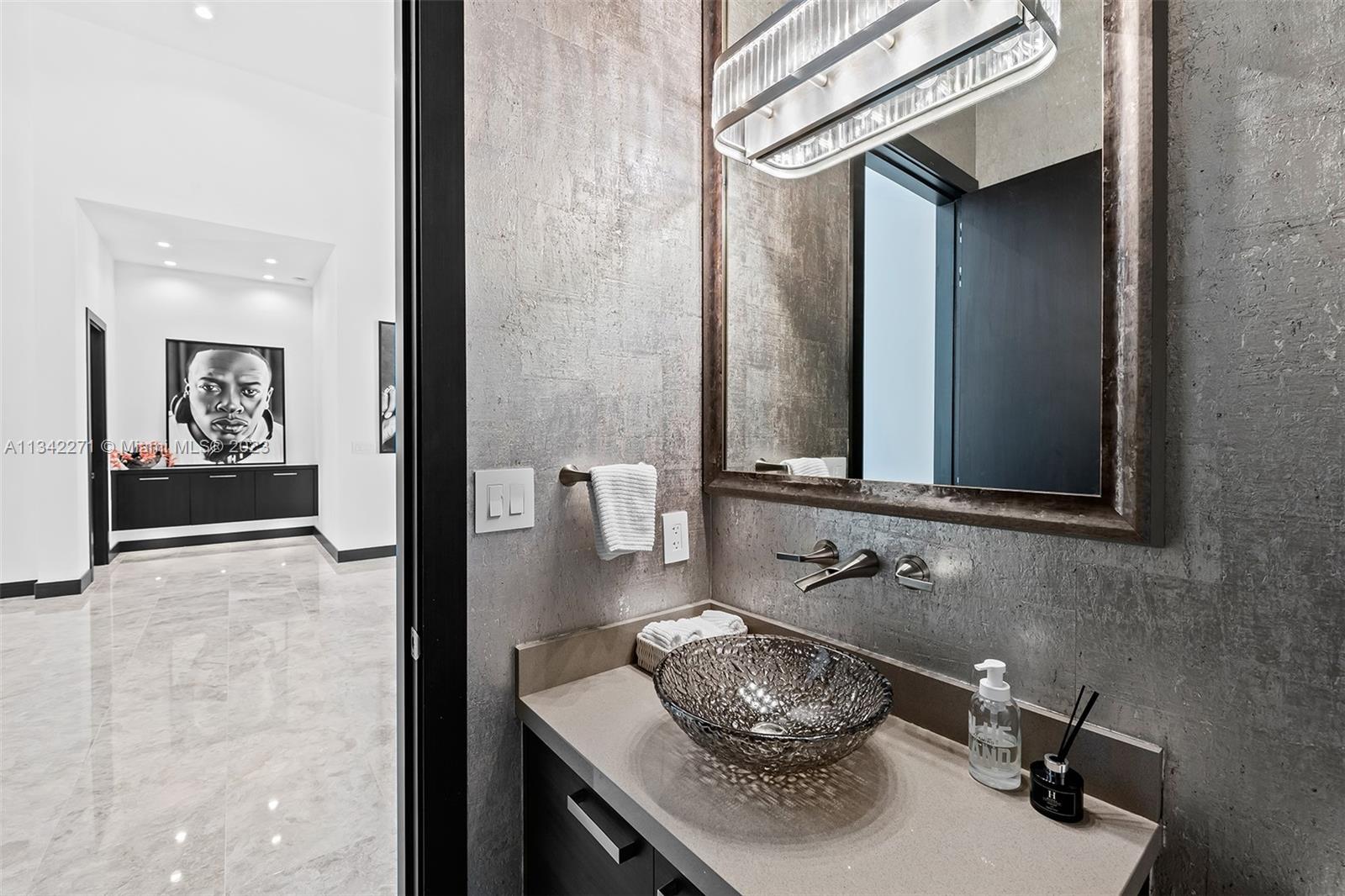 2610 Oak Park Drive Davie, FL 33325 - Photo 36 of 60 a bathroom with a sink and a mirror