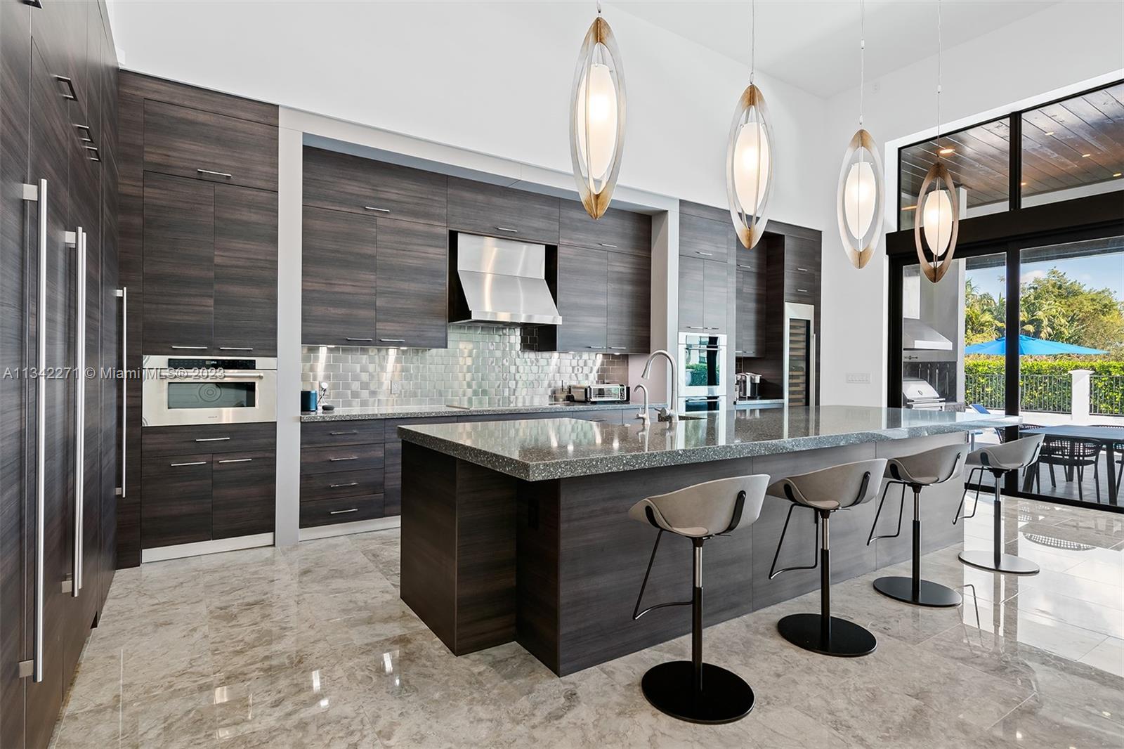 2610 Oak Park Drive Davie, FL 33325 - Photo 4 of 60 a kitchen with stainless steel appliances granite countertop a sink and a refrigerator