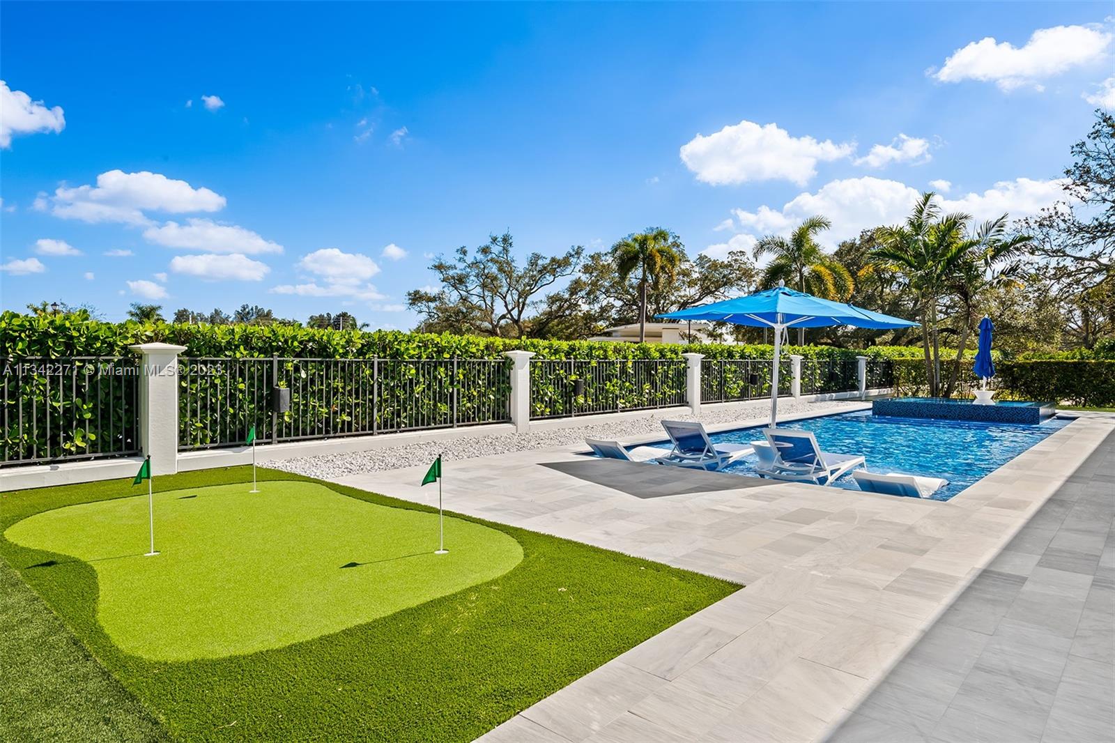 2610 Oak Park Drive Davie, FL 33325 - Photo 42 of 60 a view of a swimming pool with an outdoor seating and plants
