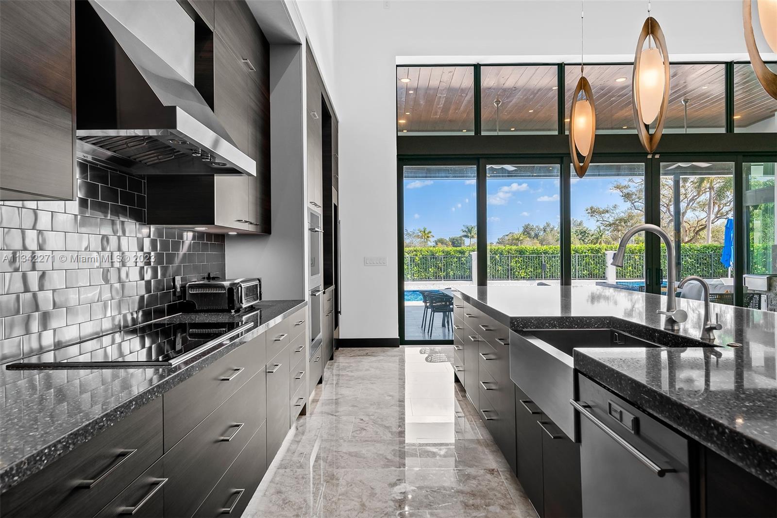 2610 Oak Park Drive Davie, FL 33325 - Photo 6 of 60 a kitchen with stainless steel appliances granite countertop a sink and a stove