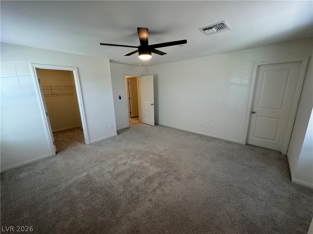 2821 Alcobaca Street Henderson, NV 89044 - Photo 21 of 24 A spacious chamber offers ample room and comfortable carpet flooring, featuring a practical walk-in closet.