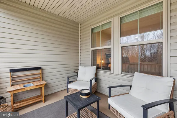 a view of a patio with table and chairs with wooden floor and fence