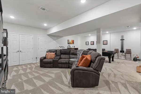 a living room with furniture kitchen and a table