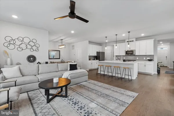 a living room with furniture and kitchen view