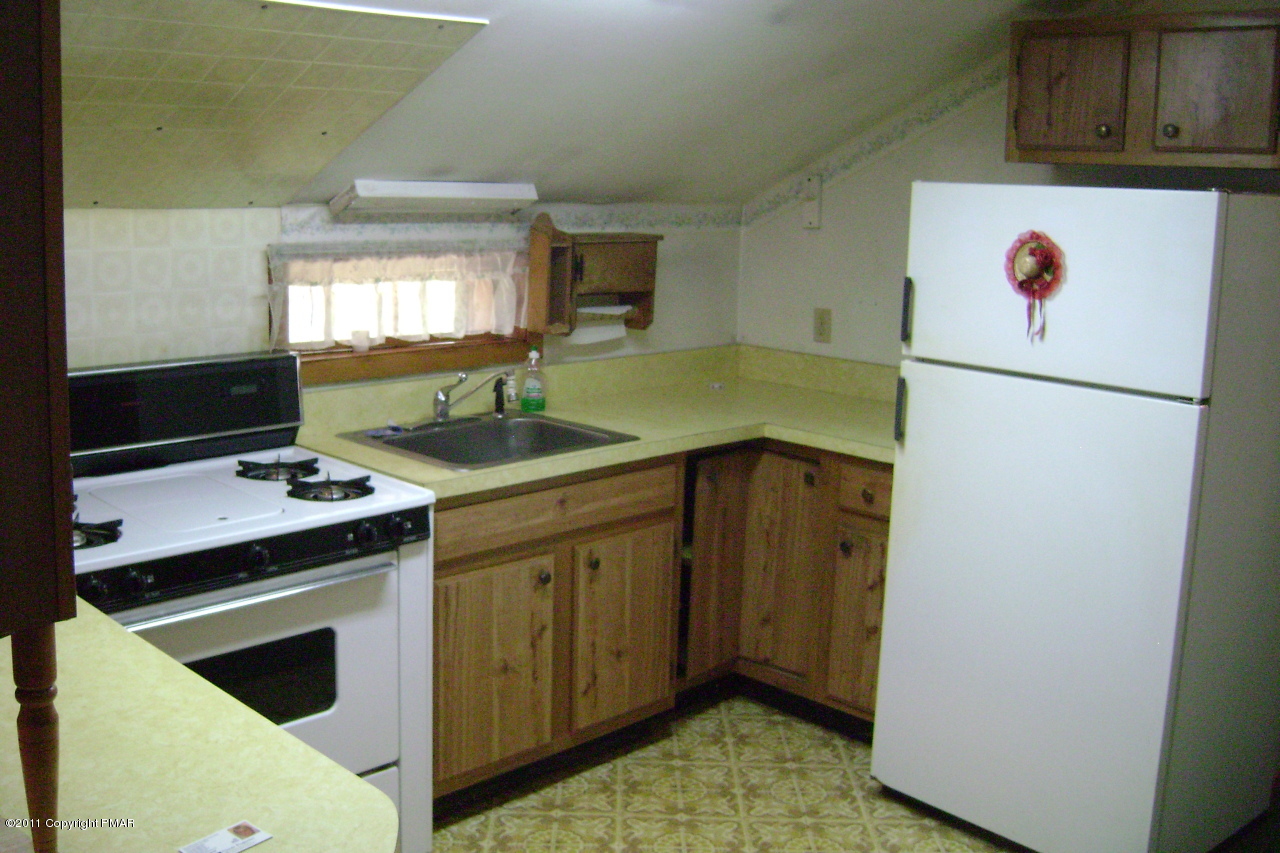 T464 West Gilbert Road Effort, PA 18330 - Photo 10 of 17 a kitchen with a refrigerator sink and stove