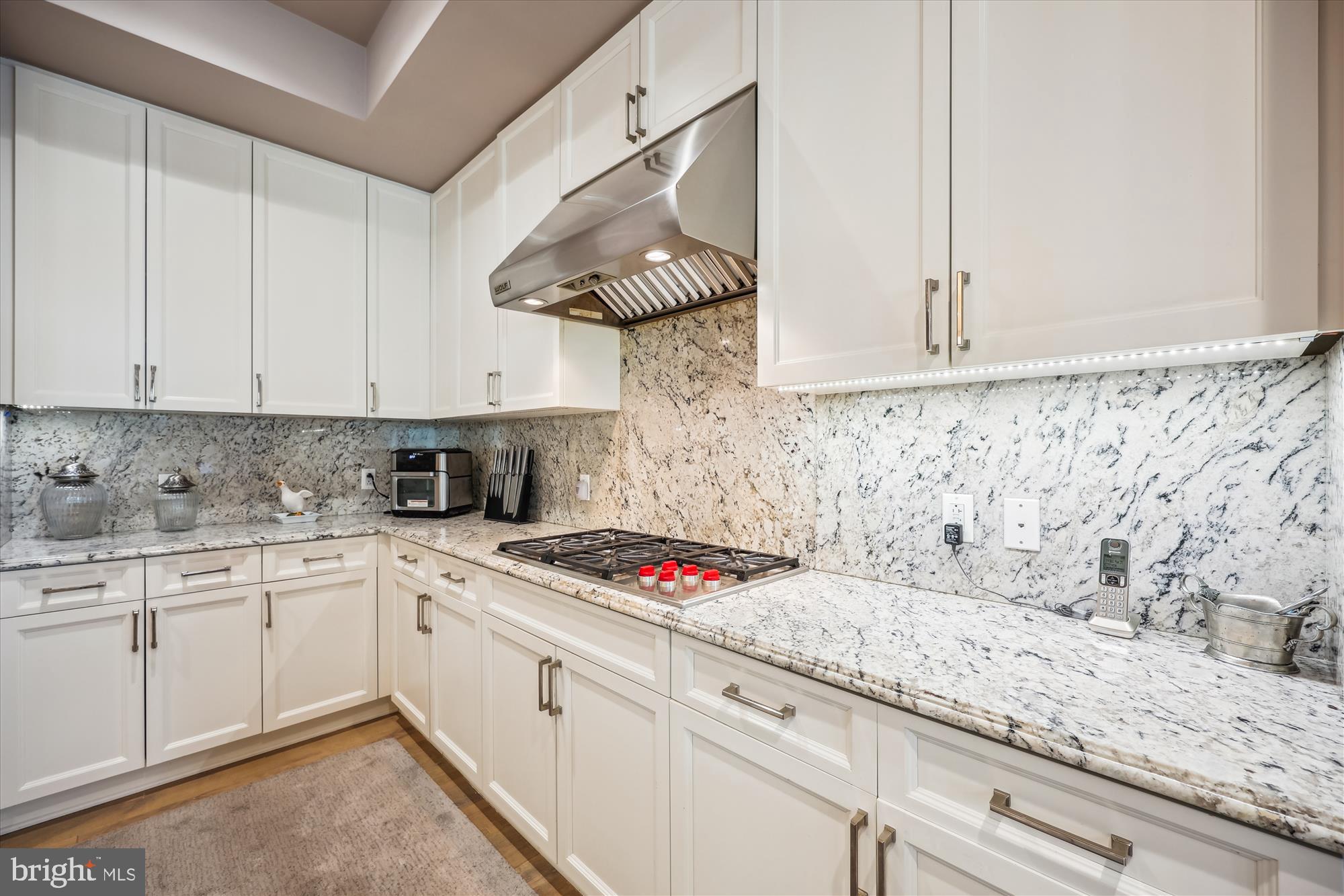 8121 River Road, Unit 451 Bethesda, MD 20817 - Photo 30 of 94 a kitchen with granite countertop a sink stainless steel appliances and cabinets