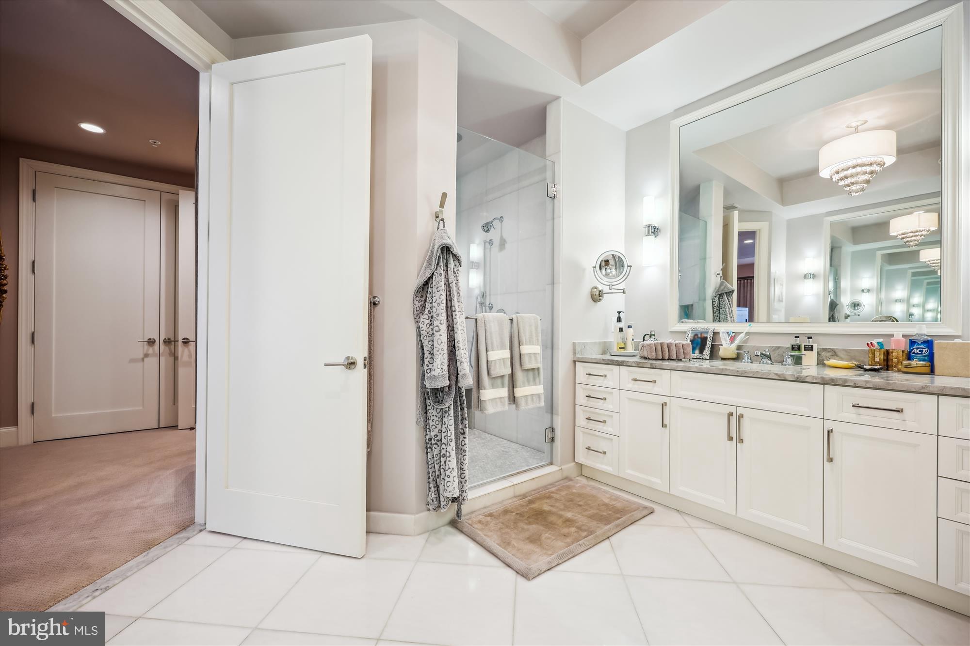 8121 River Road, Unit 451 Bethesda, MD 20817 - Photo 51 of 94 a spacious bathroom with a granite countertop sink and a mirror