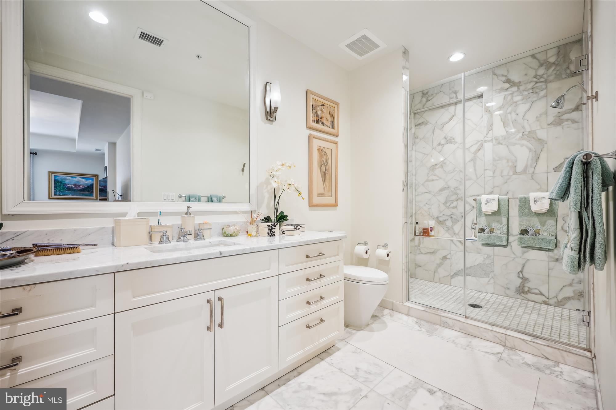 8121 River Road, Unit 451 Bethesda, MD 20817 - Photo 66 of 94 a bathroom with a double vanity sink toilet and shower