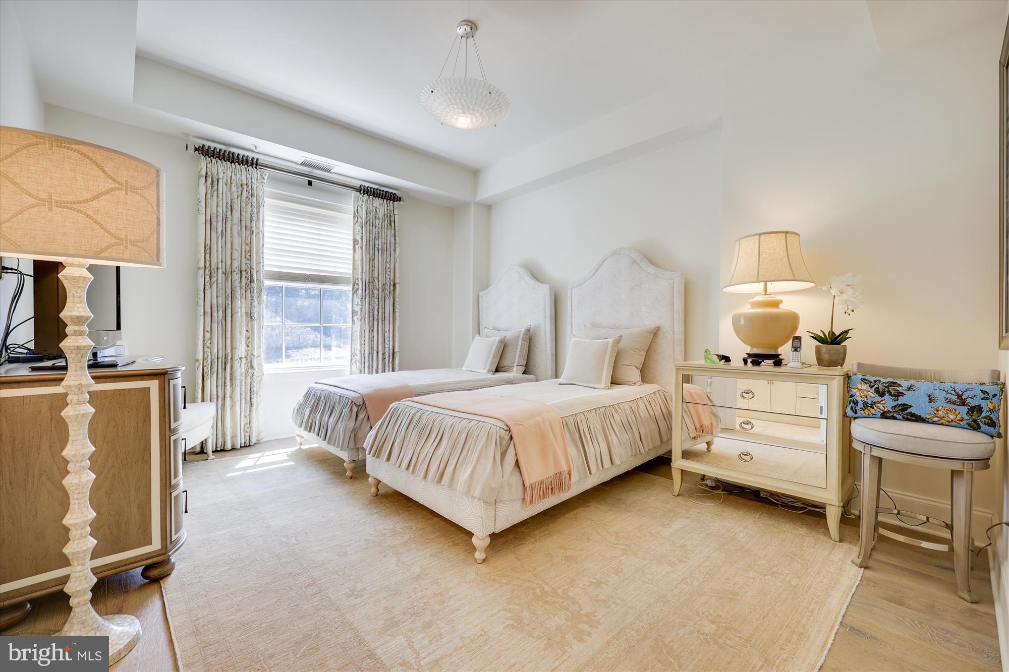 8121 River Road, Unit 451 Bethesda, MD 20817 - Photo 67 of 94 a spacious bedroom with a bed and a dresser