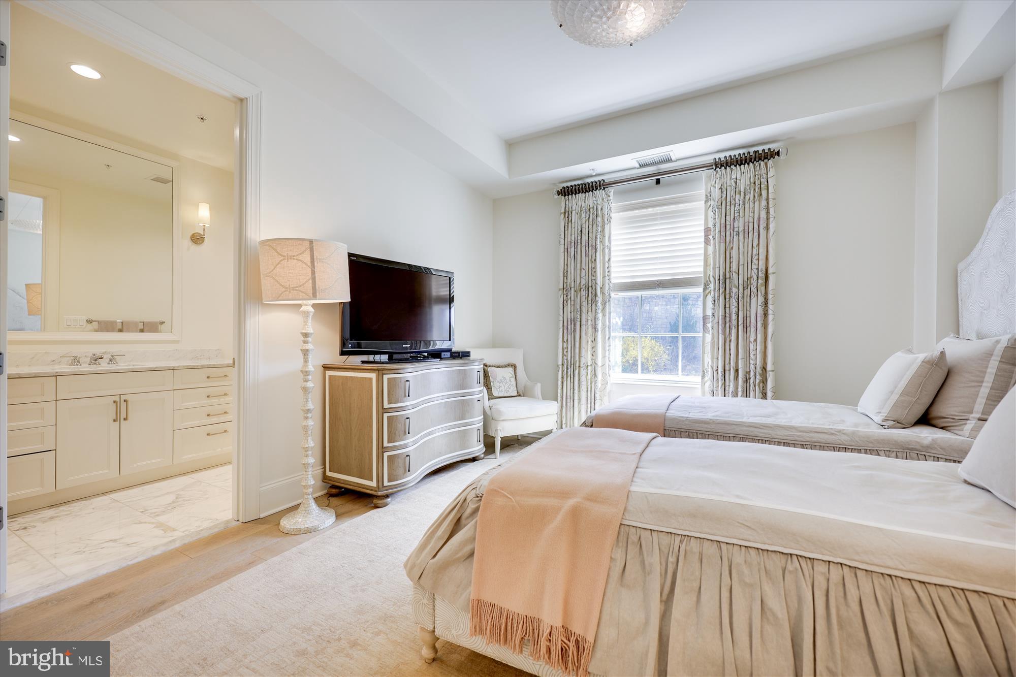 8121 River Road, Unit 451 Bethesda, MD 20817 - Photo 68 of 94 a bedroom with a bed and a flat screen tv