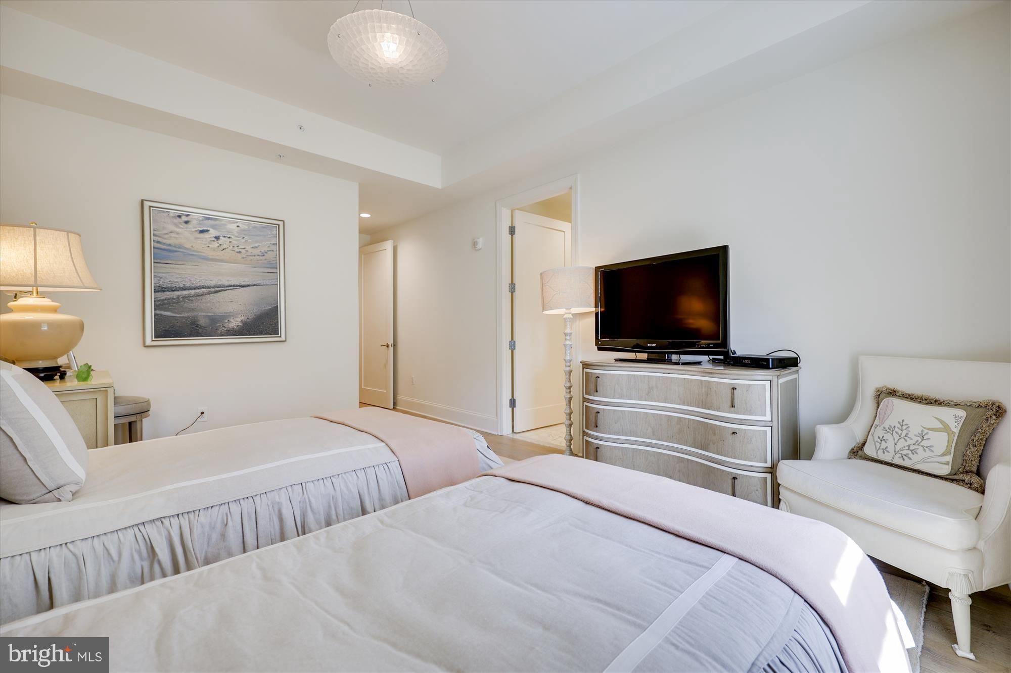 8121 River Road, Unit 451 Bethesda, MD 20817 - Photo 69 of 94 a bedroom with a bed and a flat screen tv