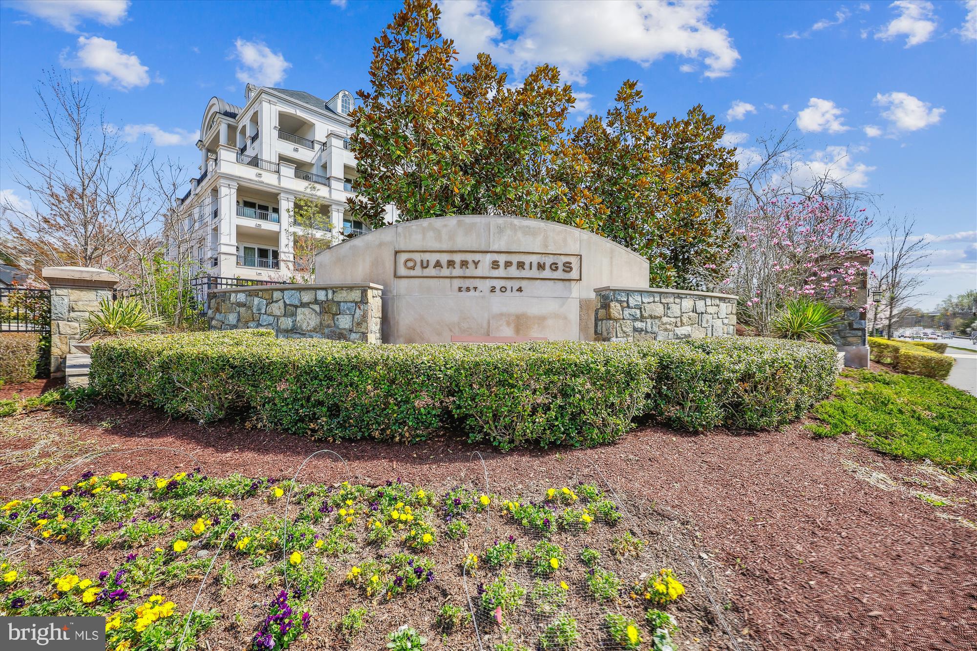 8121 River Road, Unit 451 Bethesda, MD 20817 - Photo 74 of 94 a view of a garden with a building in the background