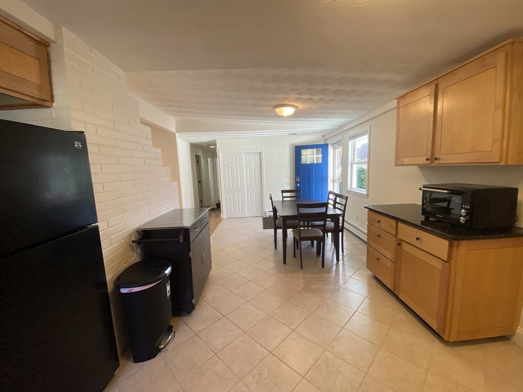 46 Griffin Road Framingham, MA 01701 - Photo 8 of 22 a kitchen with furniture a refrigerator and a stove