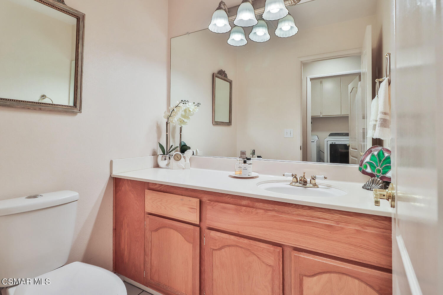 7176 University Drive Moorpark, CA 93021 - Photo 16 of 74 a bathroom with a granite countertop sink a toilet and a mirror