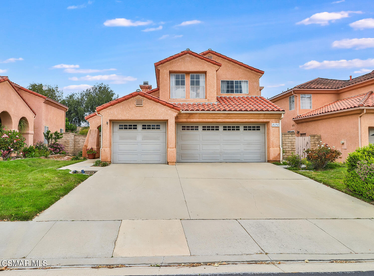7176 University Drive Moorpark, CA 93021 - Photo 2 of 74 a front view of a house with a yard and garage
