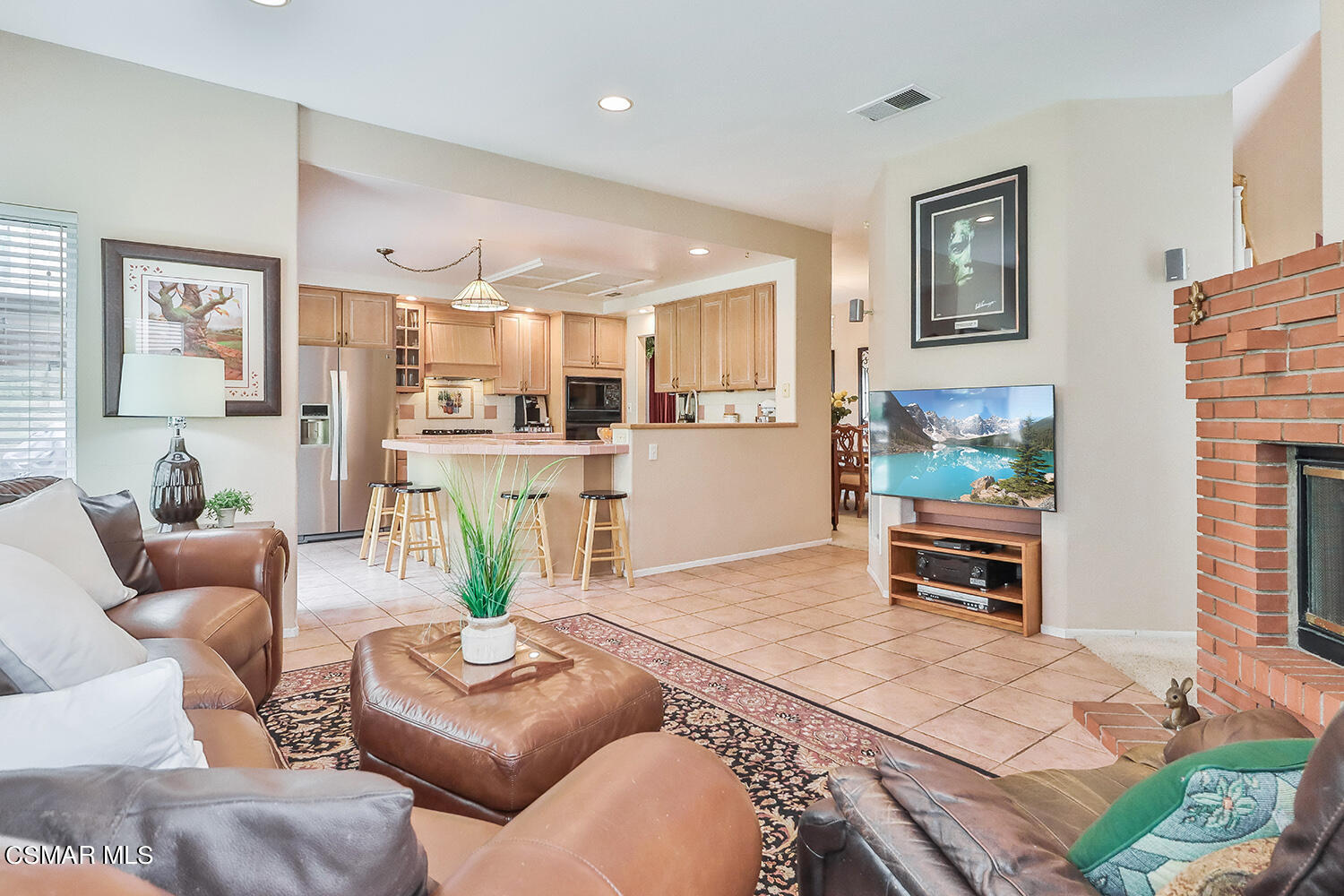 7176 University Drive Moorpark, CA 93021 - Photo 21 of 74 a living room with furniture and a dining table with kitchen view