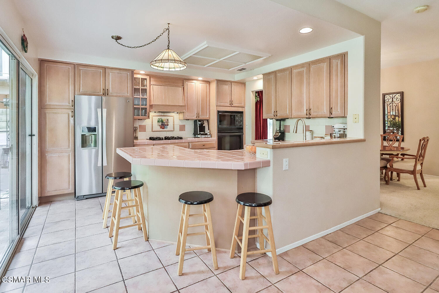 7176 University Drive Moorpark, CA 93021 - Photo 22 of 74 a kitchen with stainless steel appliances granite countertop a refrigerator and a stove top oven