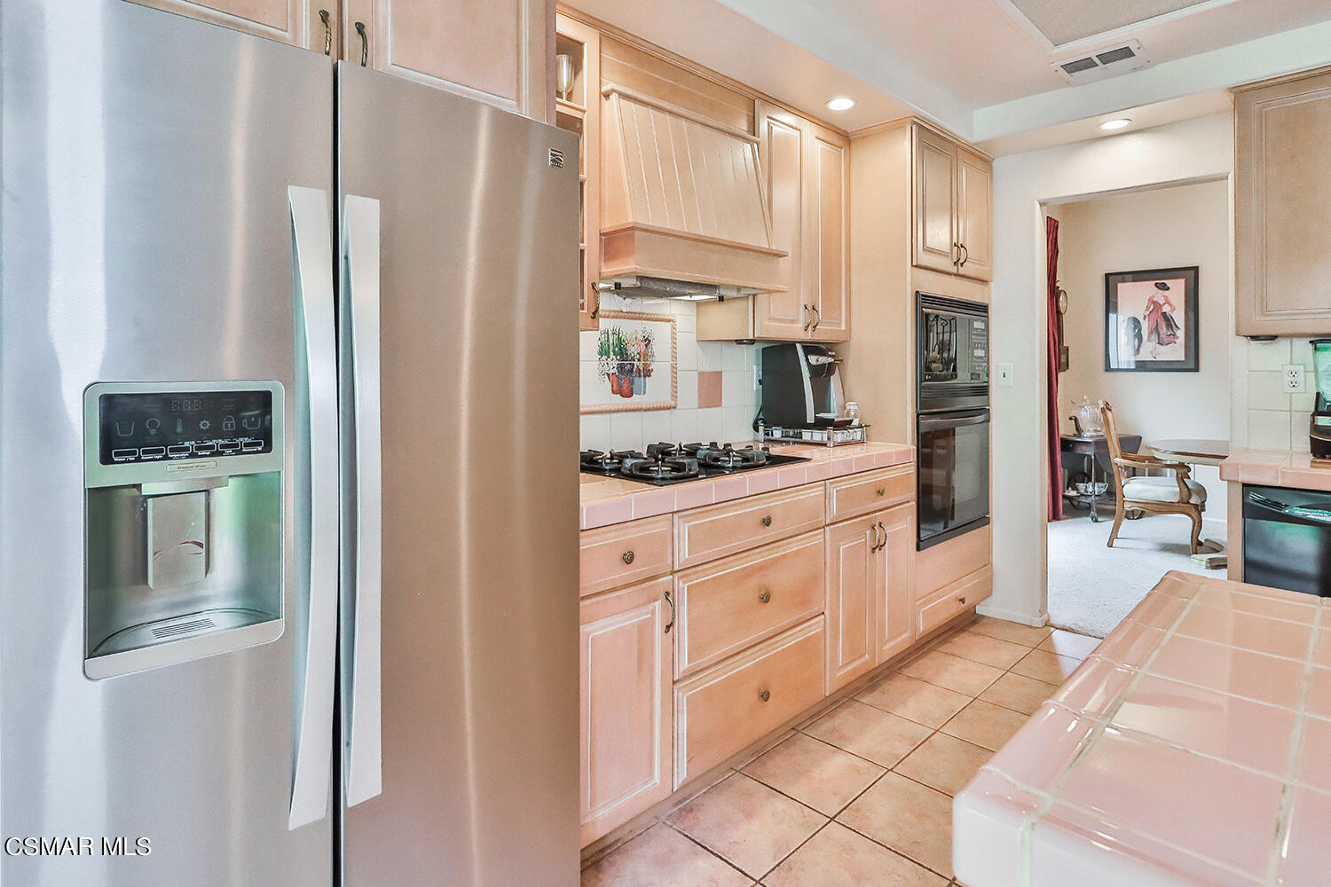 7176 University Drive Moorpark, CA 93021 - Photo 24 of 74 a kitchen with stainless steel appliances kitchen island granite countertop a refrigerator and a stove top oven