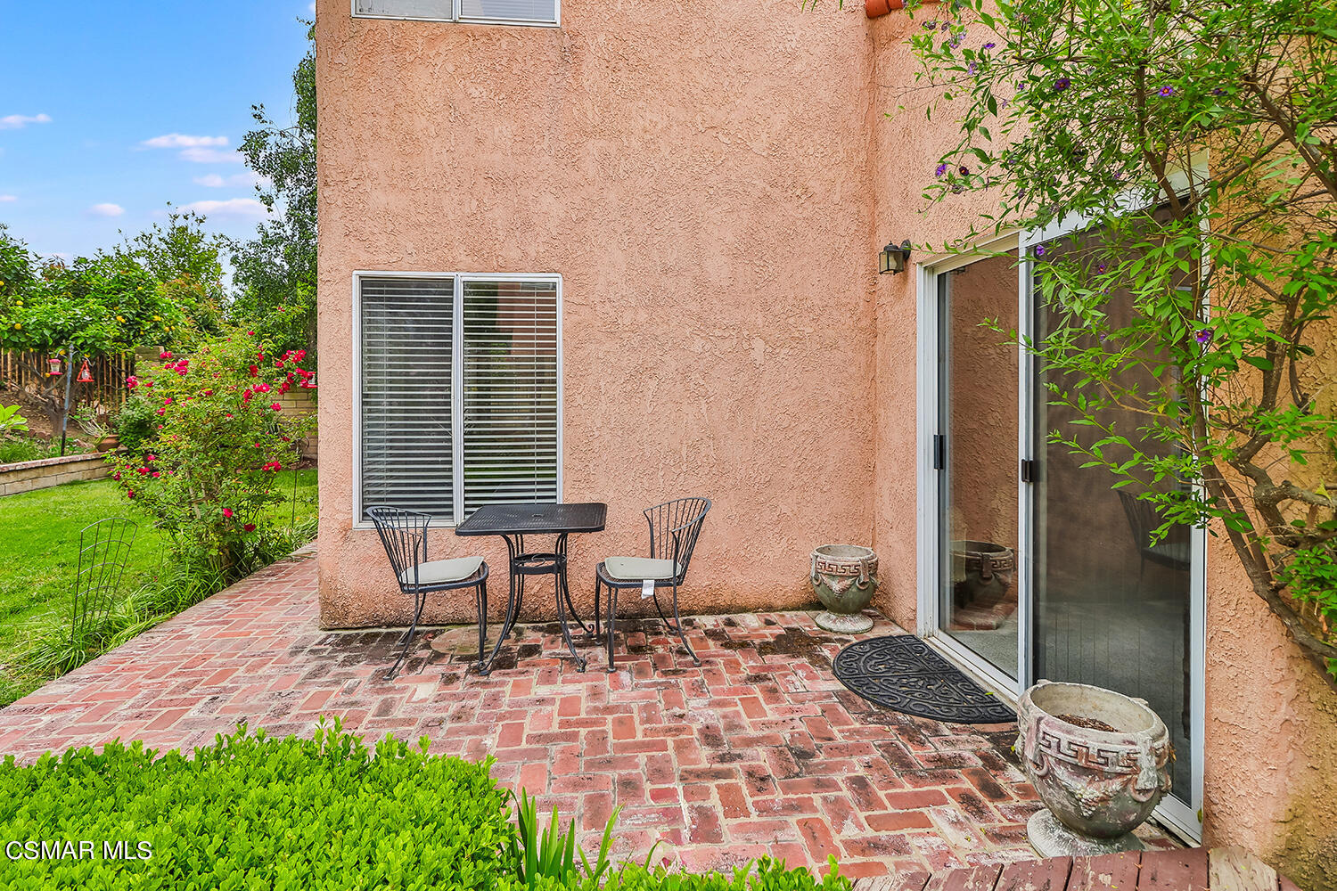 7176 University Drive Moorpark, CA 93021 - Photo 57 of 74 a view of a patio with table and chairs near a garden