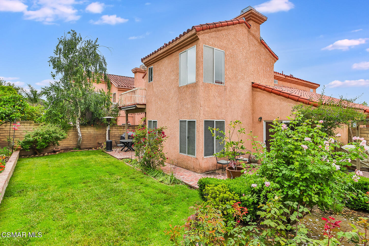 7176 University Drive Moorpark, CA 93021 - Photo 62 of 74 a backyard of a house with table and chairs plants and large tree