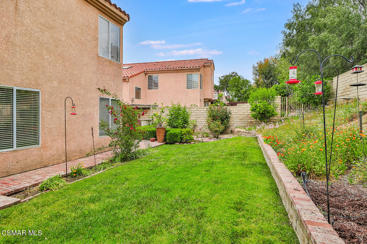7176 University Drive Moorpark, CA 93021 - Photo 63 of 74 a view of a house with a backyard and a garden
