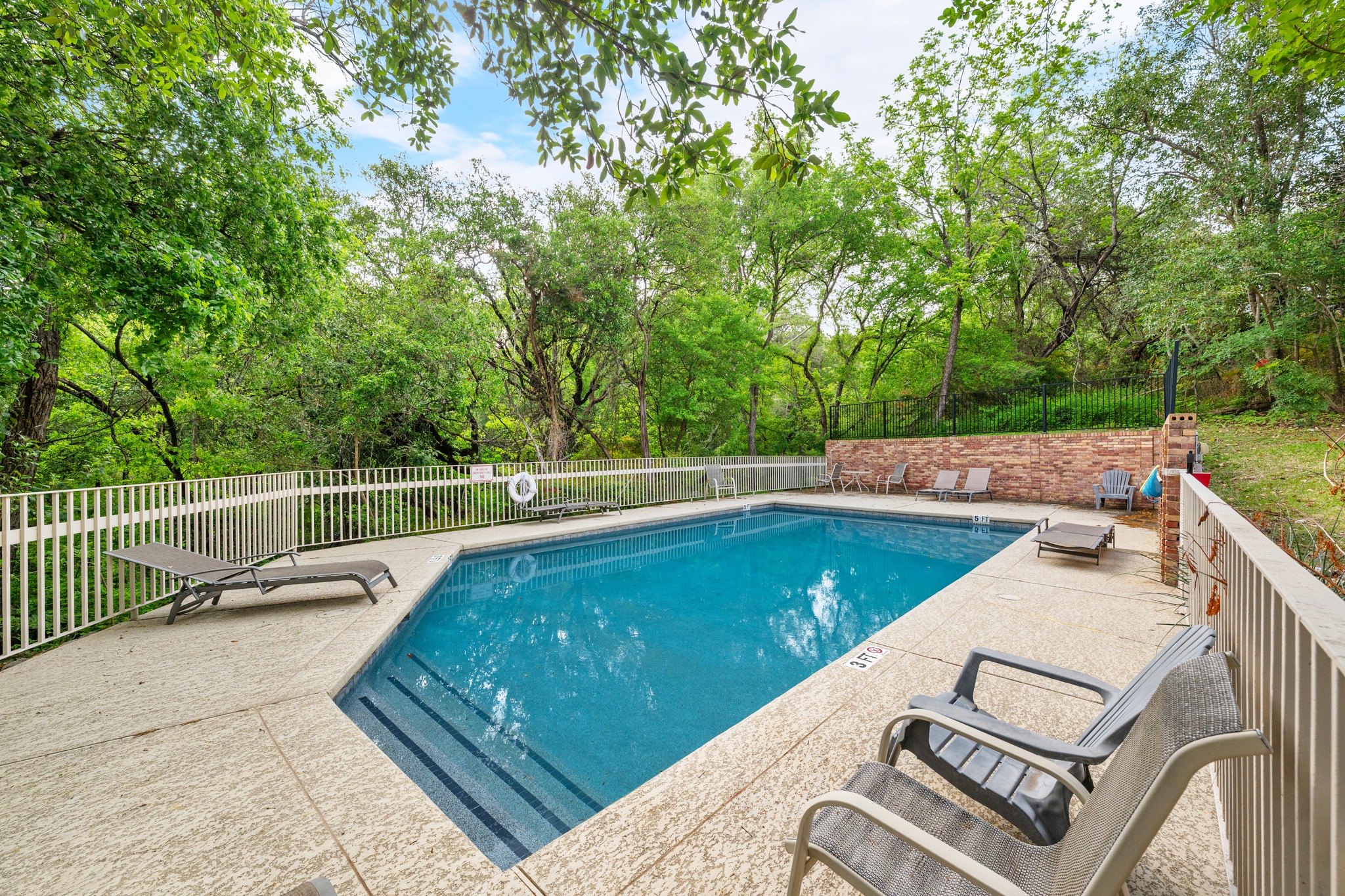3845 Ranch Road 2222, Unit 19 Austin, TX 78731 - Photo 4 of 38 a view of a swimming pool with a lounge chair