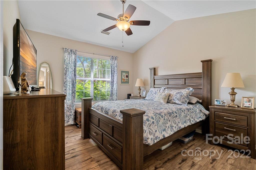 7192 Brookridge Drive Denver, NC 28037 - Photo 14 of 30 a bedroom with a bed and a chandelier next to a window