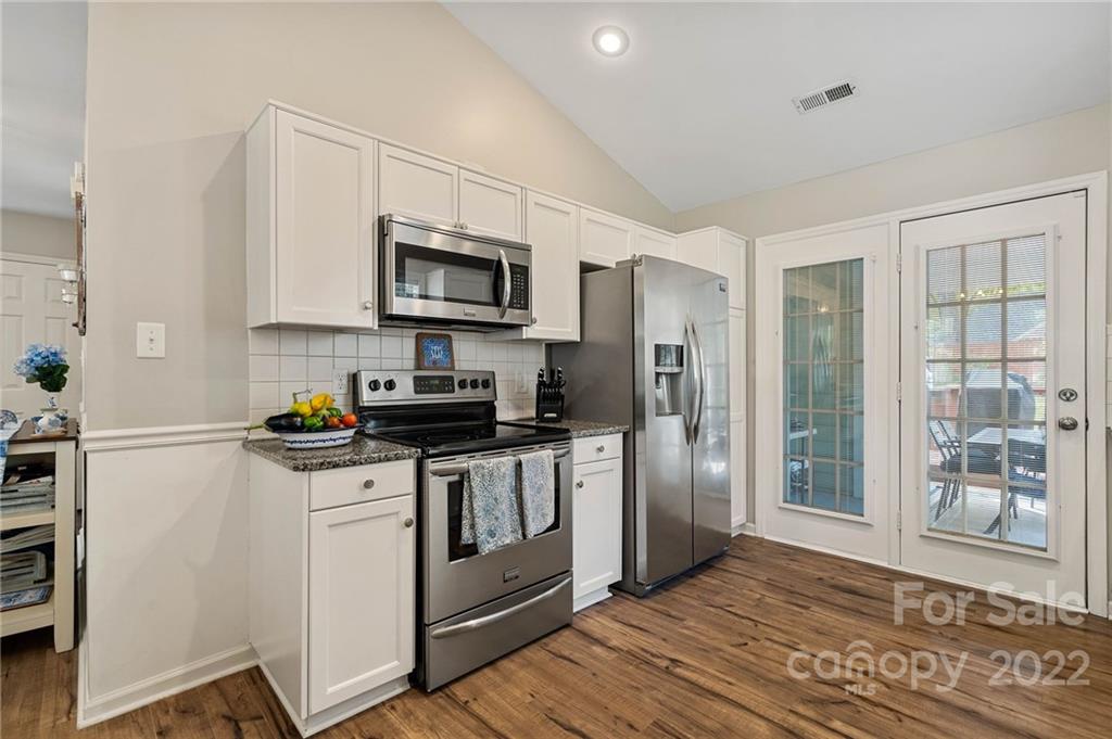 7192 Brookridge Drive Denver, NC 28037 - Photo 9 of 30 a kitchen with stainless steel appliances granite countertop a refrigerator a stove top oven a sink and dishwasher