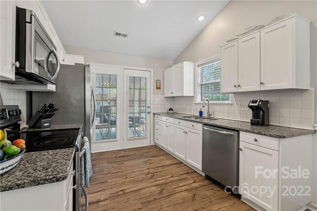 7192 Brookridge Drive Denver, NC 28037 - Photo 10 of 30 a kitchen with stainless steel appliances granite countertop a stove a sink and a refrigerator