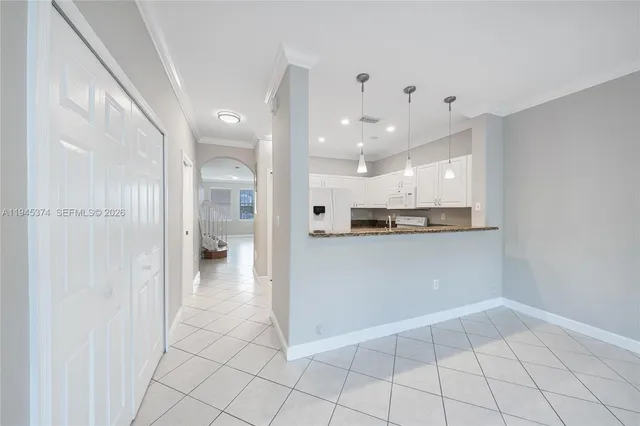 a view of a kitchen with a refrigerator and a stove top oven