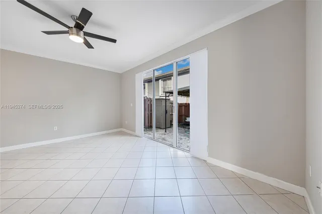 a view of a livingroom with a ceiling fan and window