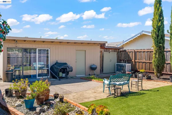 a view of a patio with table and chairs and potted plants