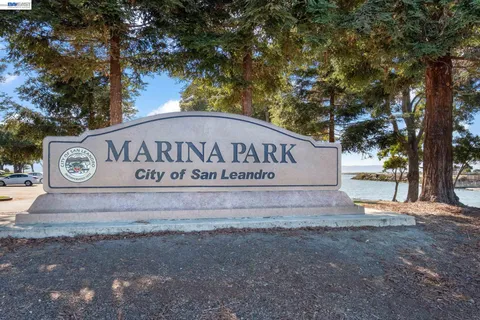 a view of outdoor space with sign board and lake view