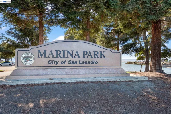 a view of outdoor space with sign board and lake view