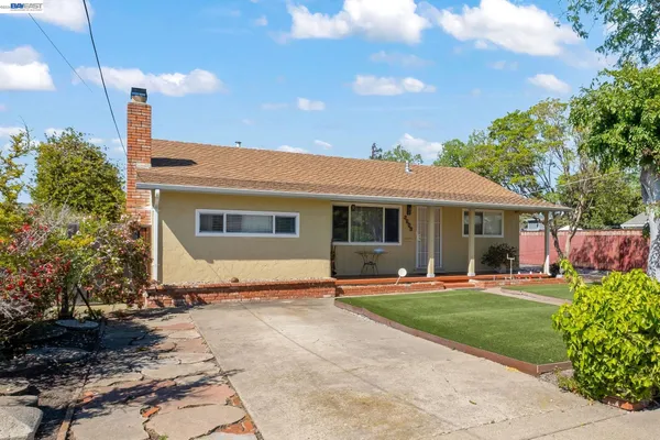 a front view of a house with a yard fire pit and outdoor seating